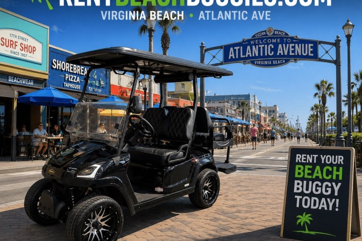 Black beach buggy on Atlantic Avenue, Virginia Beach, with rental sign and summer shops in background.